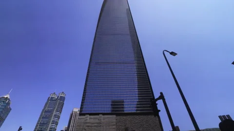A view of a sleek, modern contemporary skyscraper in Shanghai, with its gla.. Stock Footage 287016713
