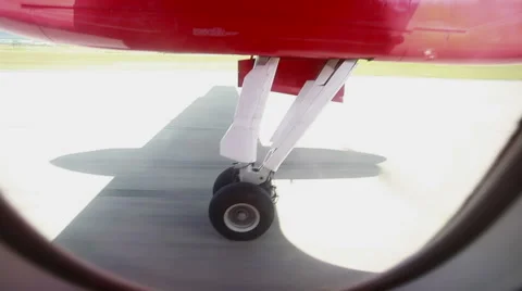 The view from small aircraft window to plane shassis durring the take off Stock Footage 61790906