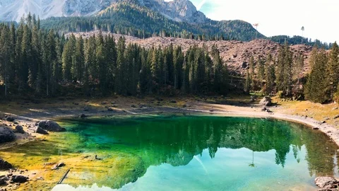 View of a small alpine Lake Carezza o Karersee located in the Dolomitesin, Italy Stock Footage 118380106