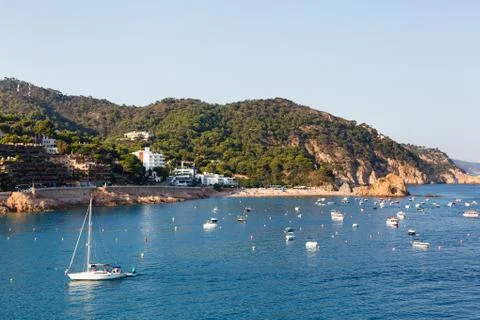 View of a small beach and coastline in Tossa del Mar in the early morning Stock Photos