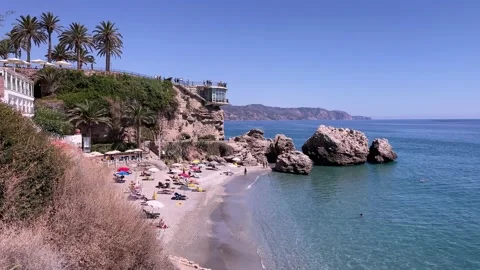 View of the small beach with people seen from Balcon de Europa Video stock 163619617