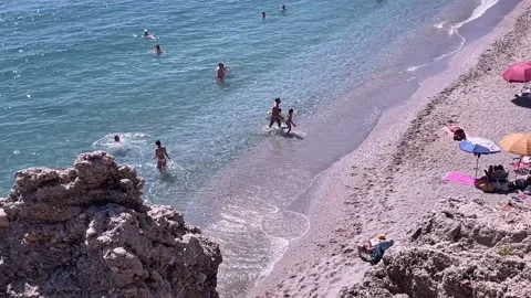 View of the small beaches as with people seen from Balcon de Europa Stock Footage 163620824