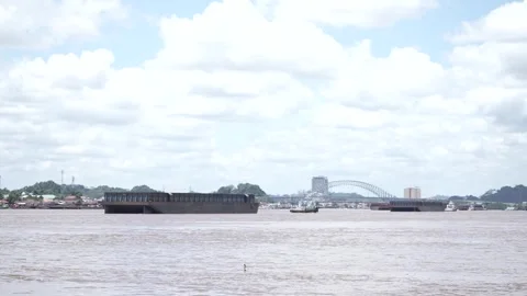 View of a small boat pulling a barge on a big river Stock Footage 256138739