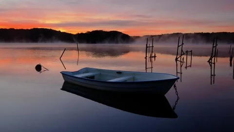 View of a small boat on Stensjon lake at sunrise, Sweden. Video stock 342281522