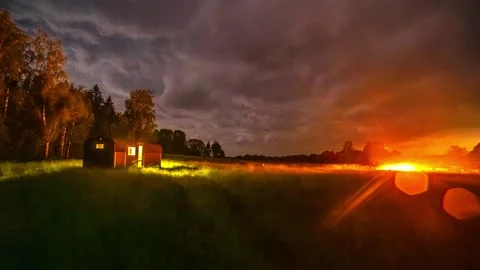 View of a small cabin in a field at night, Latvia. 库存影片 340640309