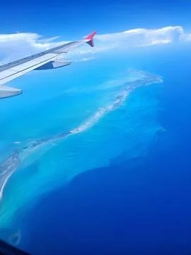 View of a small Caribbean island from inside the plane. Stock Photos
