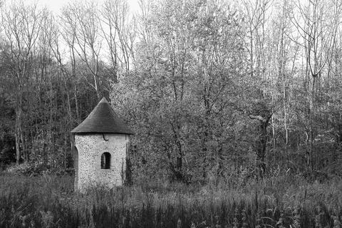View of a small chapel in a forest in grayscale in Plancenoit, Belgium Stock Photos