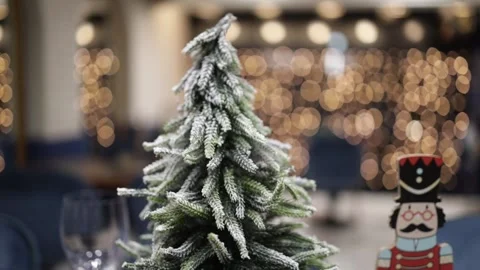 View of the small decoration fir tree and bokeh lights in the background in HD Stock Footage 196608136