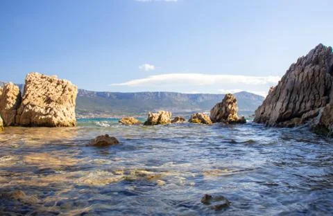 View of a small hidden beach on the adriatic sea. View low down on the bright Stock Photos