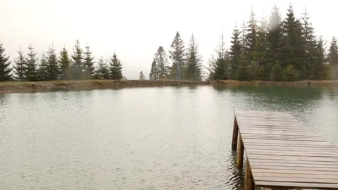 View of a small mountain lake in the rain. Stock Footage 76445393