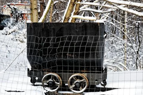 View of a small old black coal wagon in a winter landscape Stock Photos