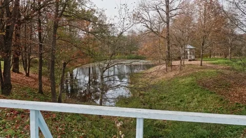View of small pond with pavilion on the shore on the territory of old estate in Stock Footage 169011949