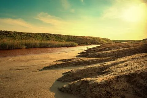 View of small red water river full of iron in beautiful steppe 스톡 사진