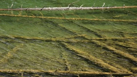 View of small ripples on the water in a a clear greenish colored mountain lake Stock Footage 135089609