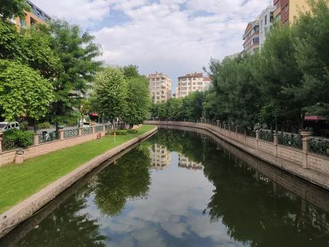 View of a small river and trees from a bridge in a park in the city of Eskişehir 스톡 사진