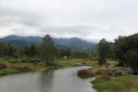 The view of the small river in the pillars and mountains, with green trees .. Stock Photos