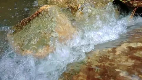 View of a small river with a rocky background Stock Footage 311743639