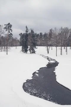 View of a small river in the winter in a snow Park Stock Photos