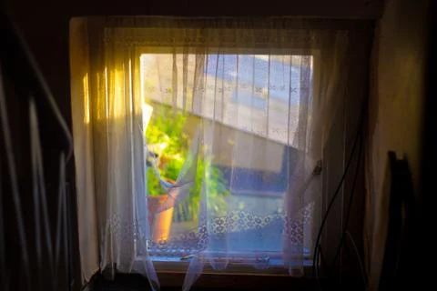View from a small square window with sunlight shining in. Stock Photos
