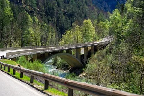 View of a small stone bridge over a mountain river in the Austrian Alps Stock Photos