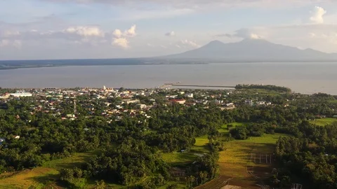 View of a small town and a volcano in the distance. Sorsogon City, Luzon Stock Footage 126524841