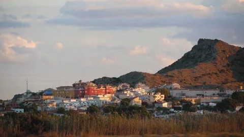 View Of A Small Town At The Foot Of A Mountain In The Evening Light Stock Footage 230095439