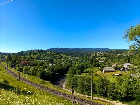 A view of a small town in the middle of a green valley Stock Photos