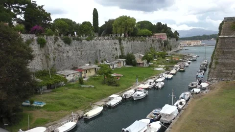 View of small water channel and boats near Old Fortress of Corfu Greece Stock Footage 140657115