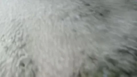 View of a small waterfall flowing rapidly. Видео 331243001