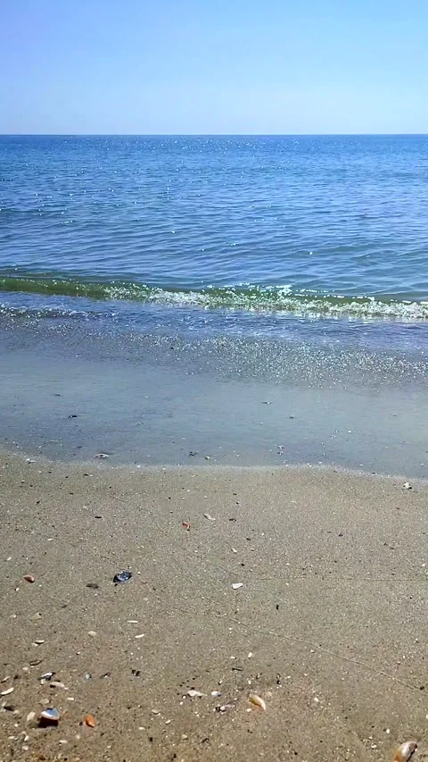 View small waves blue sea blue sky skyline sandy beach sunny summer day Vertical Stock Footage 267354080