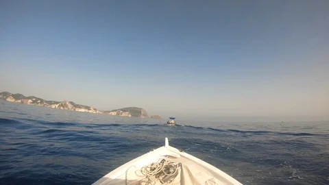 View from small white boat's bow with ropes. Sea and island. Stock Footage 119640062