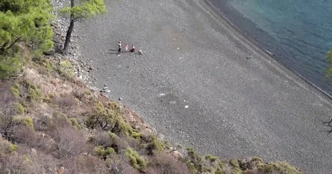 View of a Small Wild Bay With a Beach With People From Above Stock Footage 69182923