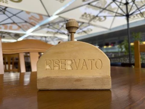 View of a small wooden reservation sign on the table of a small restaurant Stock Photos