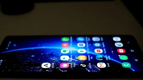 View of a smartphone,google gmail app email surfing,news,dark theme Stock Footage 126296113