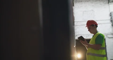 View of smiling factory engineer typing on tablet in a warehouse 스톡 동영상 127813023