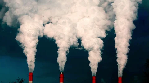 View of smoke or steam columns from four red stacks on dark blue background. Stock Footage 38615587