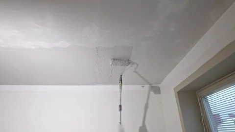 View of smooth ceiling plaster application with roller creating even texture Stock Footage 331523364