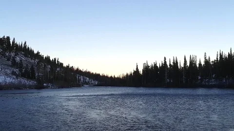 View of snow and ice on mountains and a lake full of birds, in Mammoth lake.. Stock Footage 72424902