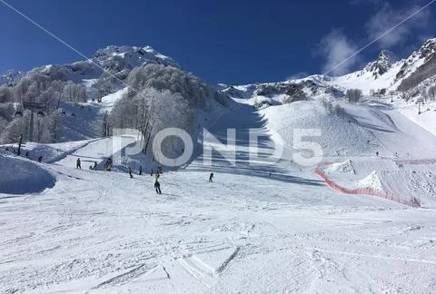 View of the snow-capped mountain peaks and chair ski lift and the slopes of.. Stock Photos