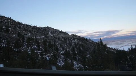 View of snow capped mountains and trees from the car window. Stock Footage 122525467