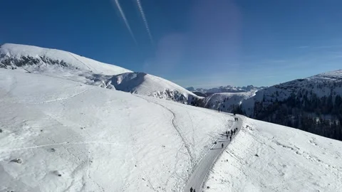 View of snow capped mountains and walking people Stock Footage 232520186