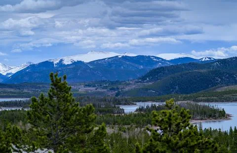 View of the snow-capped mountains in the clouds near the lake Gren. 스톡 사진