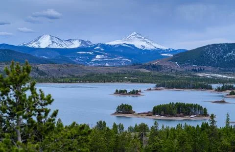 View of the snow-capped mountains in the clouds near the lake Gren. 스톡 사진
