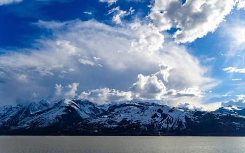 View of the snow-capped mountains in the clouds near the lake Gren. Фото