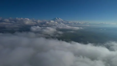 A view of the snow-capped peaks of Mount Elbrus above the clouds. Stock Footage 319444573