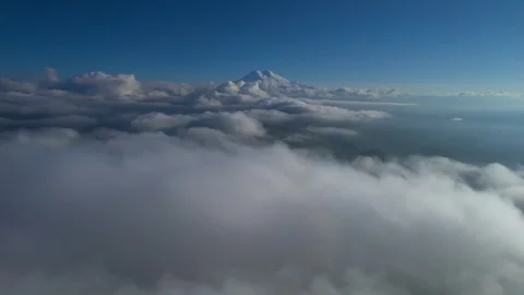 A view of the snow-capped peaks of Mount Elbrus above the clouds. Stock Footage 319444621