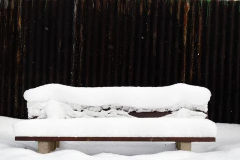 View on a snow-covered bench in winter Stock Photos