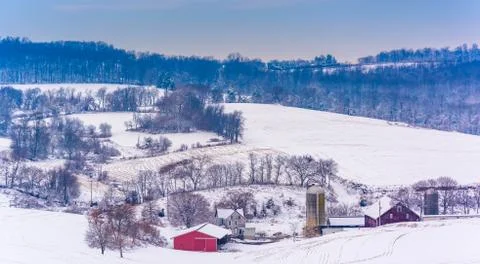 View of snow-covered farm fields and rolling hills in rural york county Stock Photos