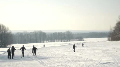 View of snow-covered fields on a sunny winter day, where skiers ride Stock Footage 264122446