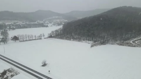 View of snow falling on farm field in western Wisconsin. Video stock 166264579